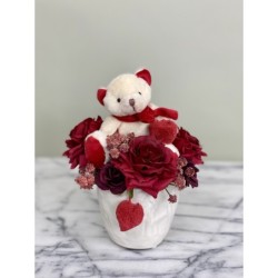Kunstblumengesteck mit Teddybär in der Vase