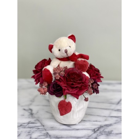 Kunstblumengesteck mit Teddybär in der Vase