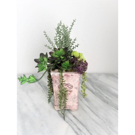 Künstliche Sukkulenten in einer Vase aus Beton